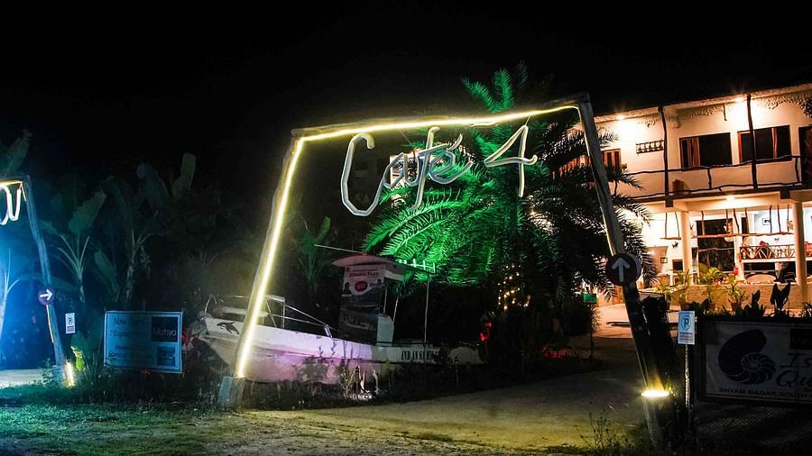Cafe exterior that is lit up at night | Matsya Island Retreat