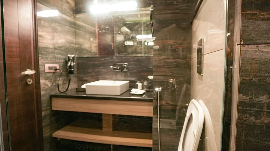 An image of an ambiently lit washroom that features toiletries, a commode and a large sink - NAMAMI BY ZENQ BANKHANDI
