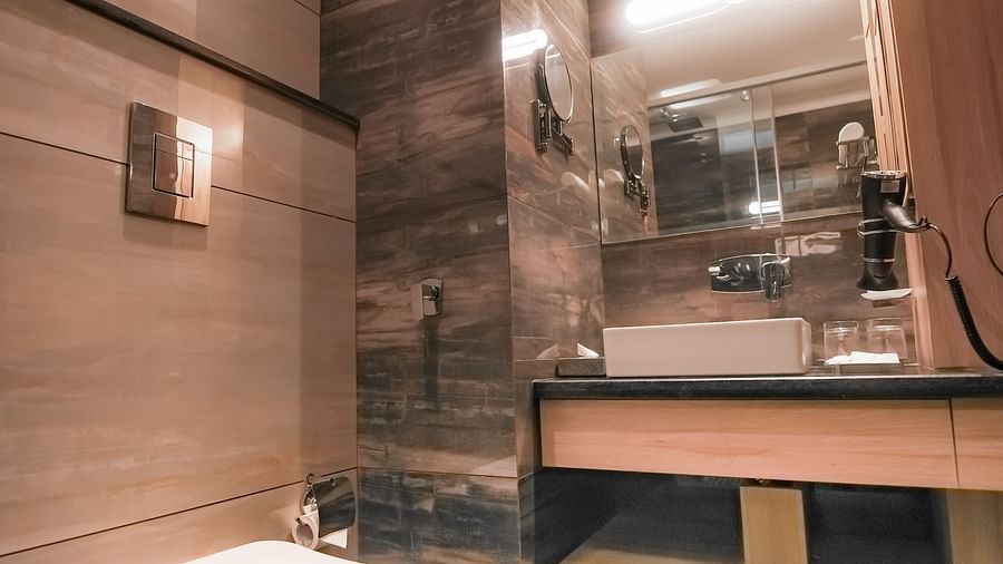 An image of a washroom in a hotel room with a large sink, a commode, and a wall-mounted sink - NAMAMI BY ZENQ BANKHANDI