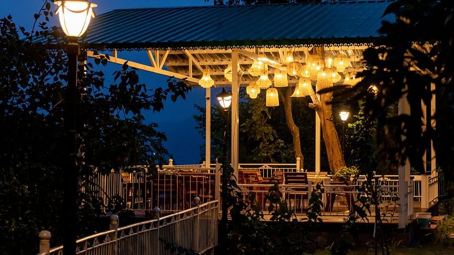 al fresco dining area with lights on in the evening - Neer Ganga Resorts