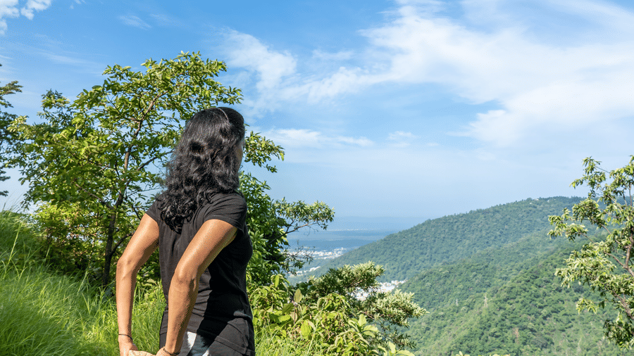a person standing on top of the mountain and enjoying the view