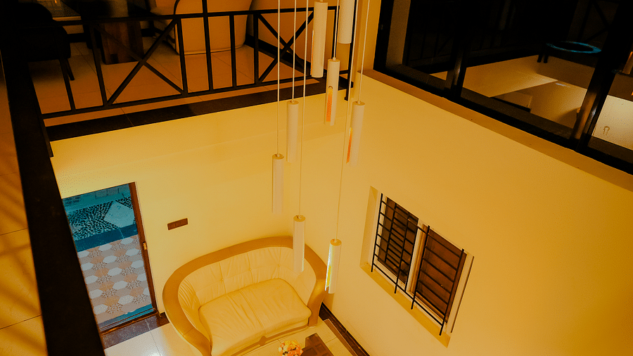 A balcony with a chair and a view, at Nirantara Resort & Spa.