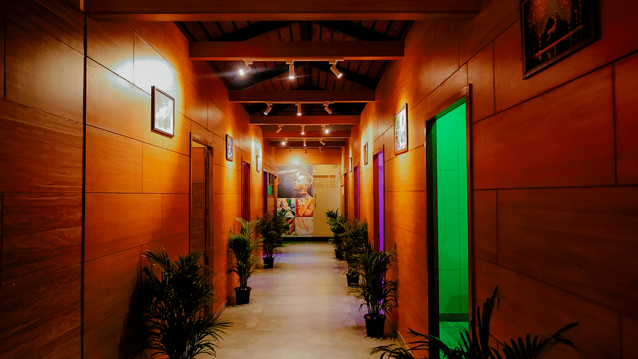 A brightly lit hallway with coluorful doors at Nirantara Resort & Spa in Bengaluru.
