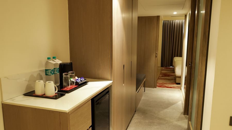 Modern room entryway with well-lit vanity and refreshments station at Ramada by Wyndham Sonipat Murthal