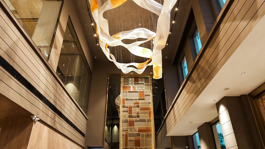 Grand hotel lobby with artistic chandelier and high ceilings at Ramada by Wyndham Sonipat Murthal
