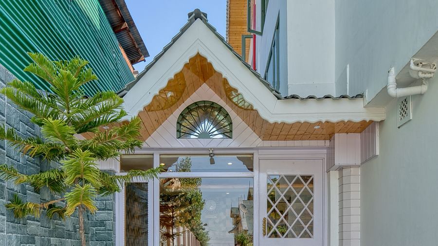 Outside view of Royal Comfort Regency entrance, with charming architecture and a welcoming front path.