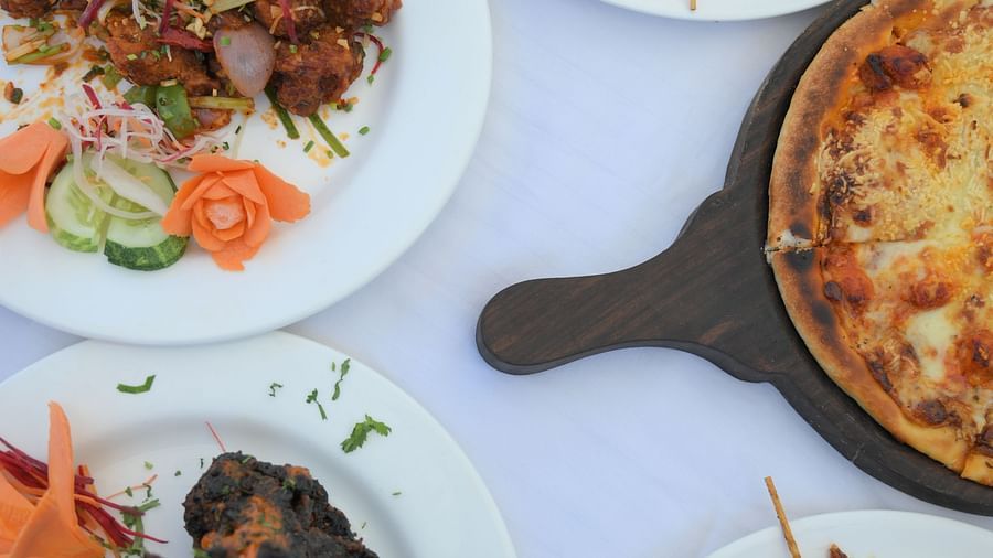 A vibrant spread of Indian dishes beautifully presented at Royal Comfort Regency, perfect for food lovers exploring local cuisine.