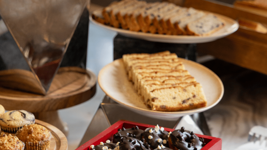 An assortment of 1 small decorative red cart holding sweets on a buffet table at Sands Point Hotel, Pondicherry.
