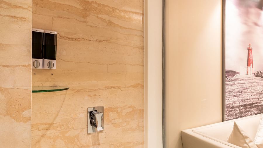 Modern bathroom featuring a glass shower enclosure and amenities- TGI Grand Fortuna, Krishnagiri Main Road, Hosur