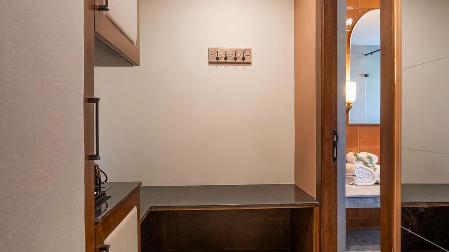 Narrow hallway with built-in storage cupboards at The Chamomile Estate.