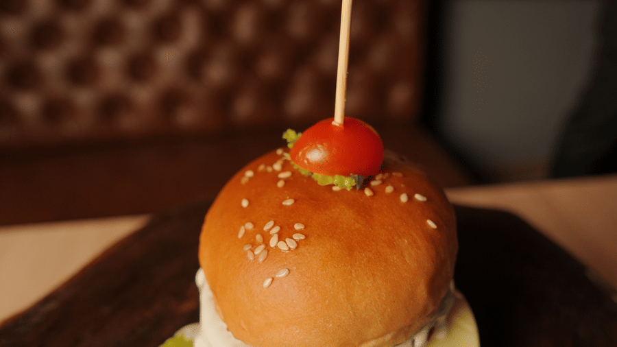 A burger placed on a plate at Citrine Hotel.
