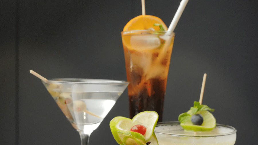 Different sized glasses placed on a table with drinks in it at Citrine Hotel.