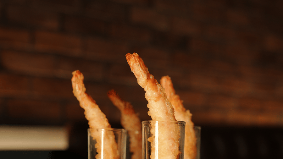 Trio of signature cocktails displayed on a bar counter with artistic presentation