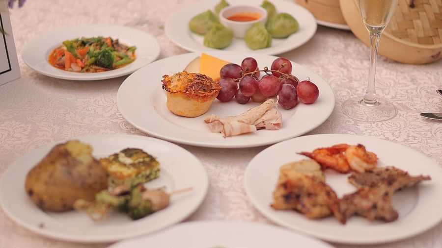 Image featuring an elegant fine dining setup with a gourmet spread of appetisers and mains