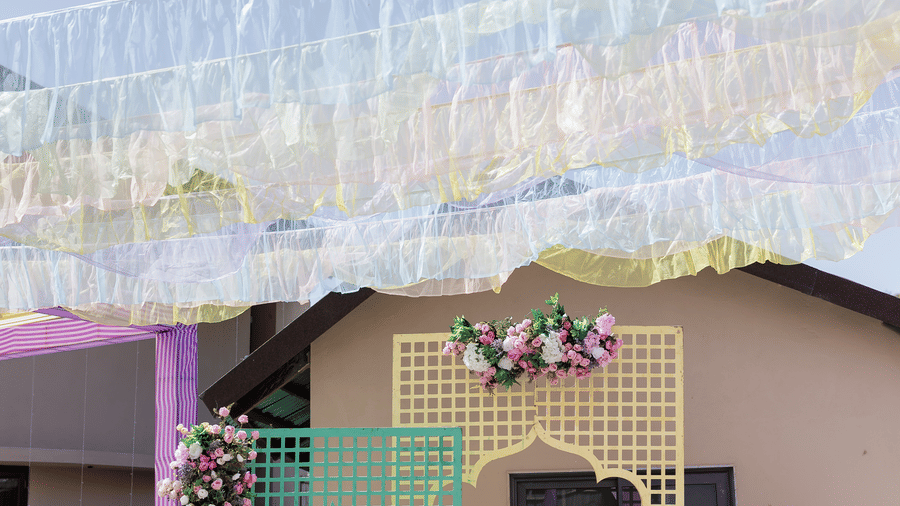 An outdoor wedding venue is illuminated during the night, showing the building and decorations | The Qualia Resort Club & Brewery, Udaipur