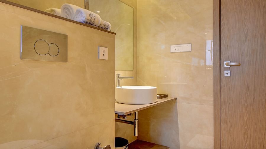 A hotel bathroom with a toilet and a sink, bright interior lighting - The SSK Solitaire Boutique Hotel & Spa, Gangapur Road - Nashik