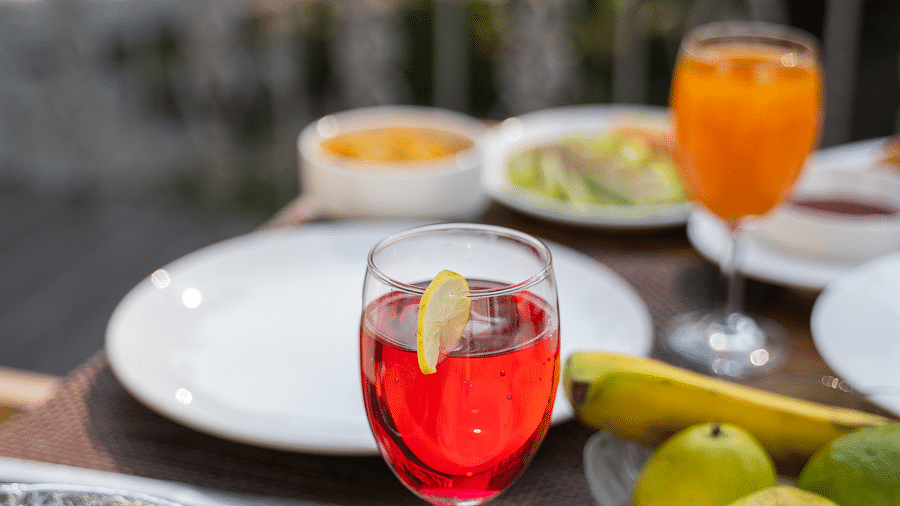 A close up shot of a drink placed along with various meals on the table at the Sylvan Retreat, Dehradun.