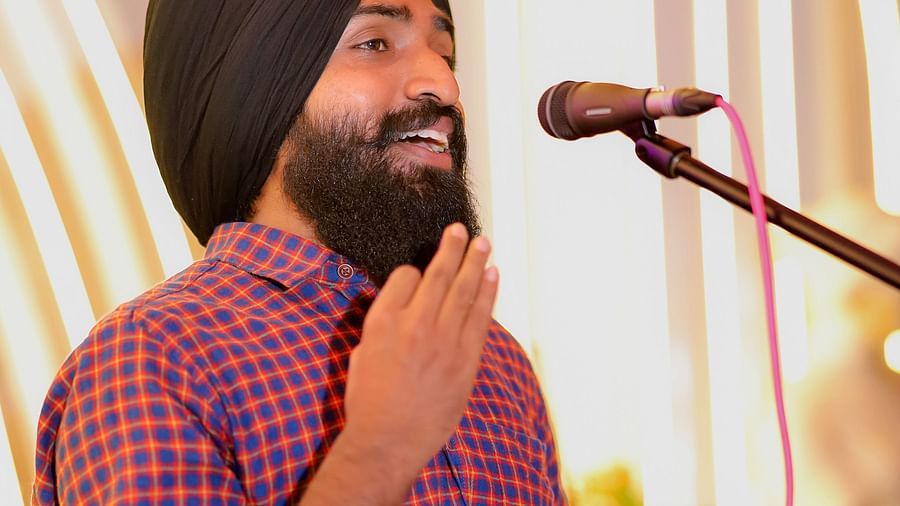 An image of a man singing on a mic at Themis Barbecue House, Ambala