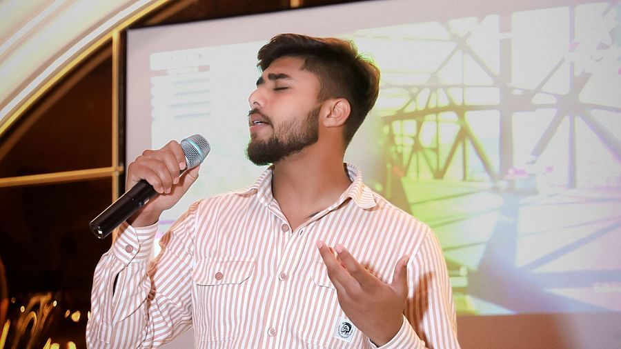 An image of a man singing on a stage at Themis Barbecue House, Ambala