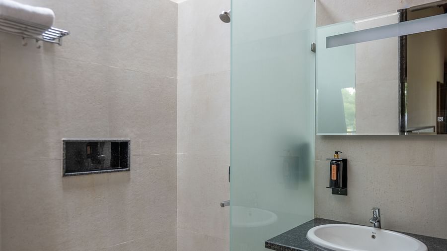 Modern bathroom inside Ananta Villa – 3-Bedroom Villa at Trance Veechika Resort, Vikarabad, featuring a glass shower and sleek fittings.