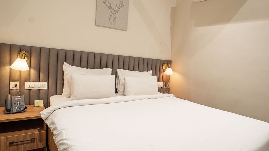 An image of a room with king size bed, bed side tables, lamps - Trance Veechika Resort, Vikarabad