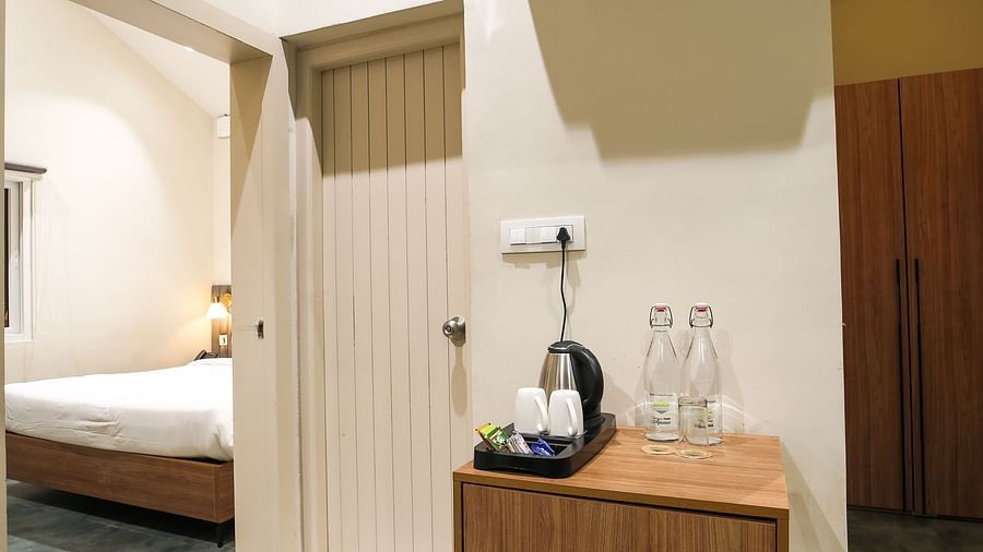 An image of room with separate living area with tea coffee maker - Trance Veechika Resort, Vikarabad