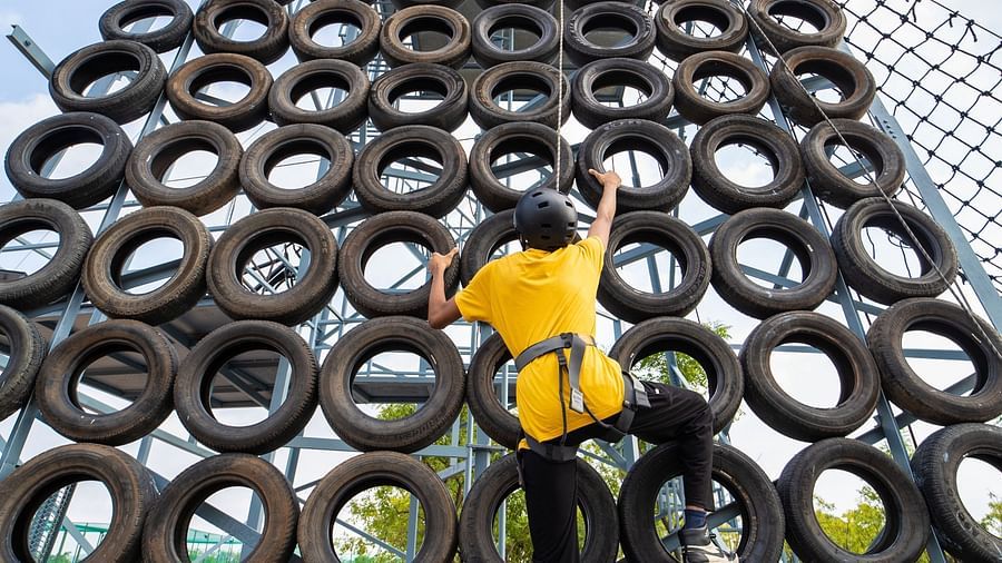 An image of a person doing the activity of tyre climbing - Trance Veechika Resort, Vikarabad