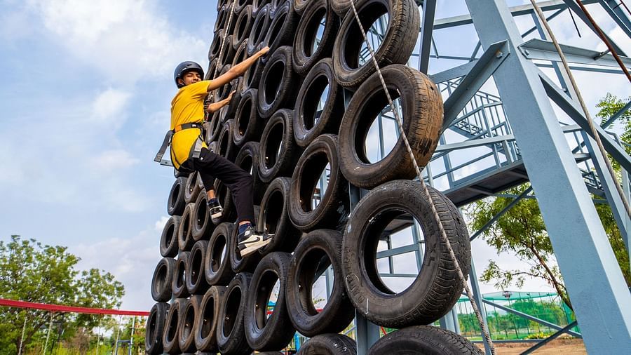 An image of a person doing the activity of tyre climbing - Trance Veechika Resort, Vikarabad