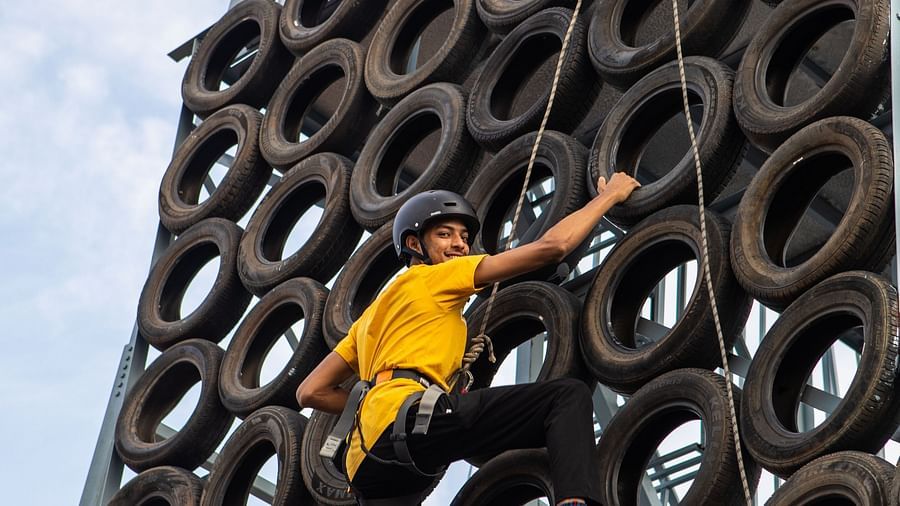 An image of a person doing the activity of tyre climbing - Trance Veechika Resort, Vikarabad