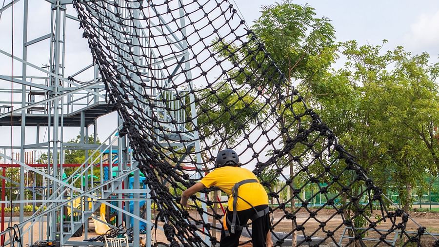 An image of a person doing the activity of net climbing - Trance Veechika Resort, Vikarabad