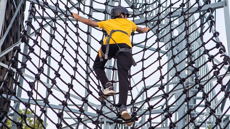 An image of a person doing the activity of net climbing - Trance Veechika Resort, Vikarabad