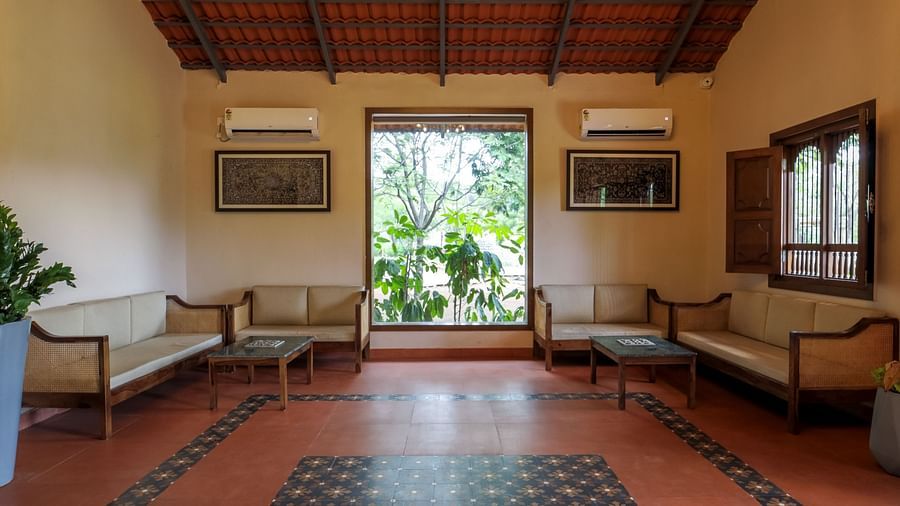 An image of a lobby at the resort with a chandelier and sofas - Trance Veechika Resort, Vikarabad