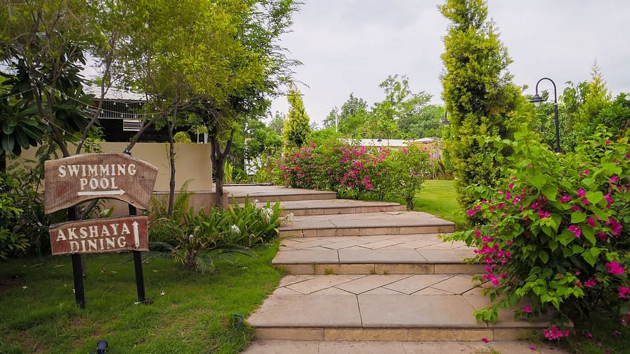 A facade image of a pathway with greenery on both sides - Trance Veechika Resort, Vikarabad