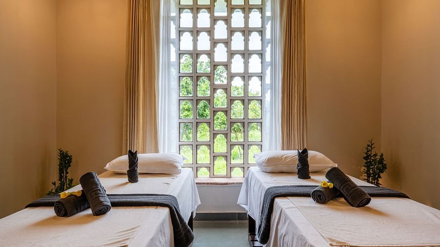 A close up shot of the beds in the spa with beds and ambient lighting - Utsav Camp