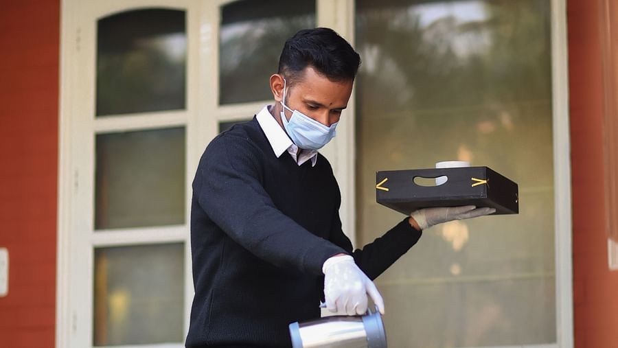 Our highly-trained staff prepping the table for tea time - Lamrin Boutique Cottages Rishikesh