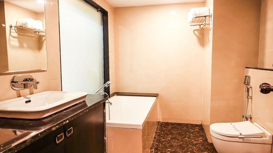 Executive room washroom with modern amenities at Vagator Downtown, Goa 