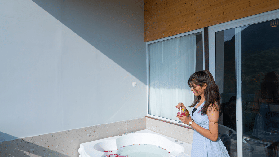 A woman walking at the Sajjan Villa Balcony at Bamboo Saa Resort and Spa, Udaipur.