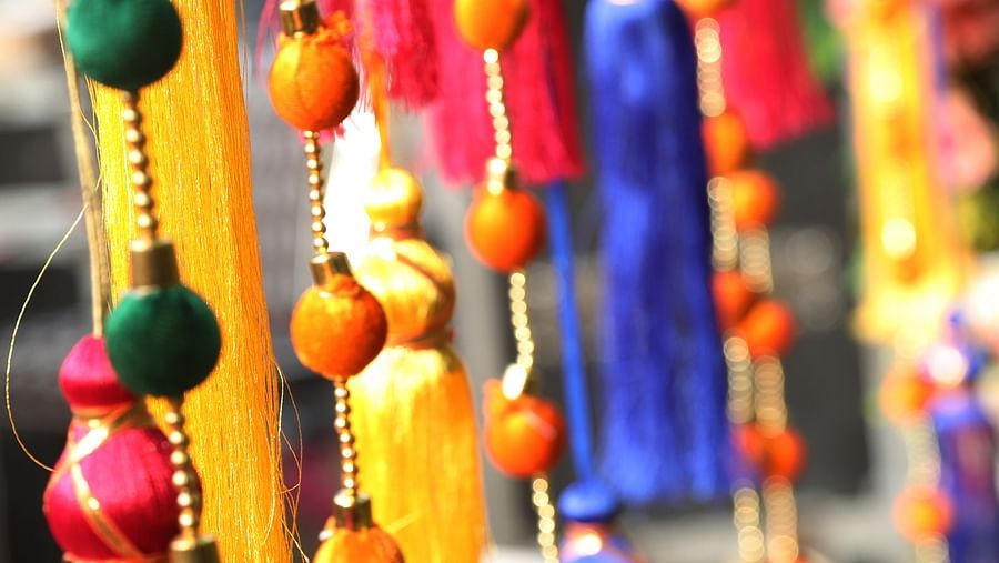 Close-up of colorful hanging tassel decorations at Tisya Farms, Gurgaon.