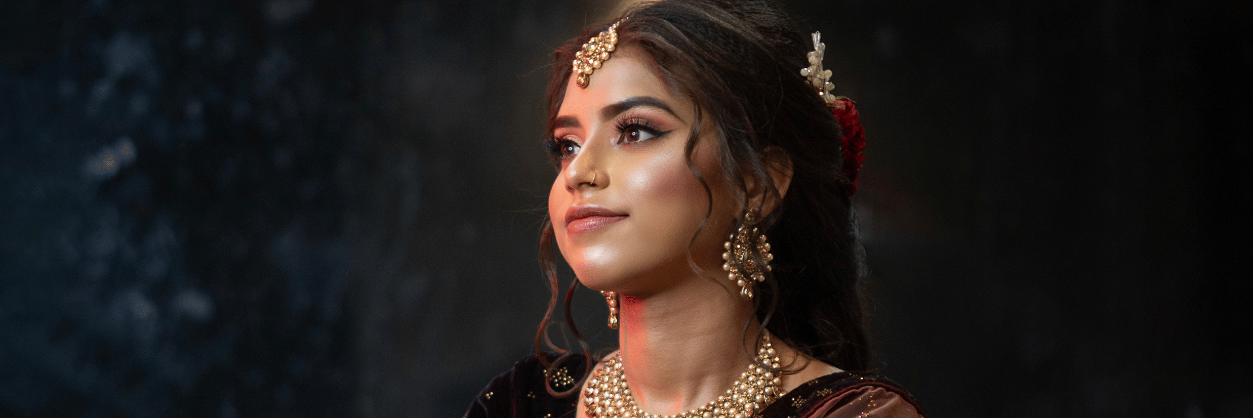 A woman dressed as a bride posing for the camera.
