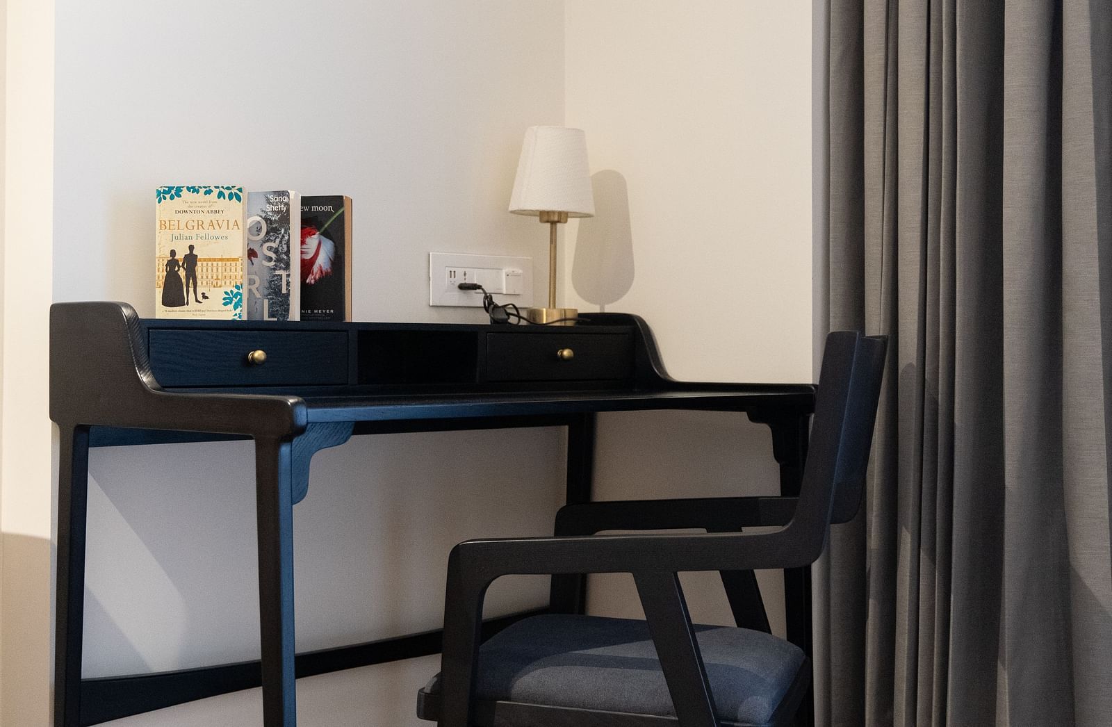 Study table with items placed on it and a chair at Nivasana Manali.