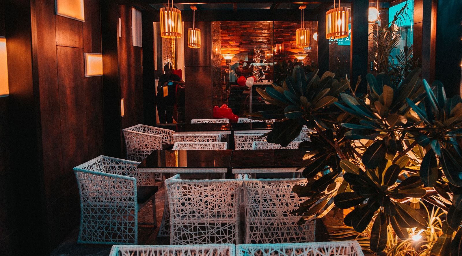 view of the interior of a rooftop restaurant with tables and chairs in clusters - Hotel Park Elanza, Chennai