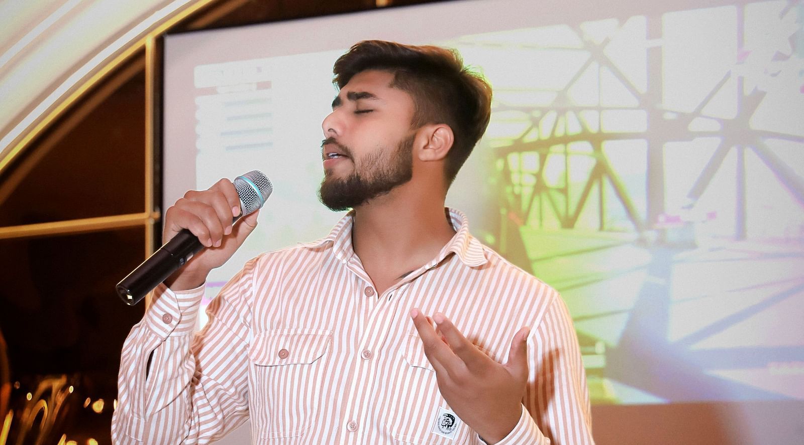 An image of a man singing on a stage at Themis Barbecue House, Ambala