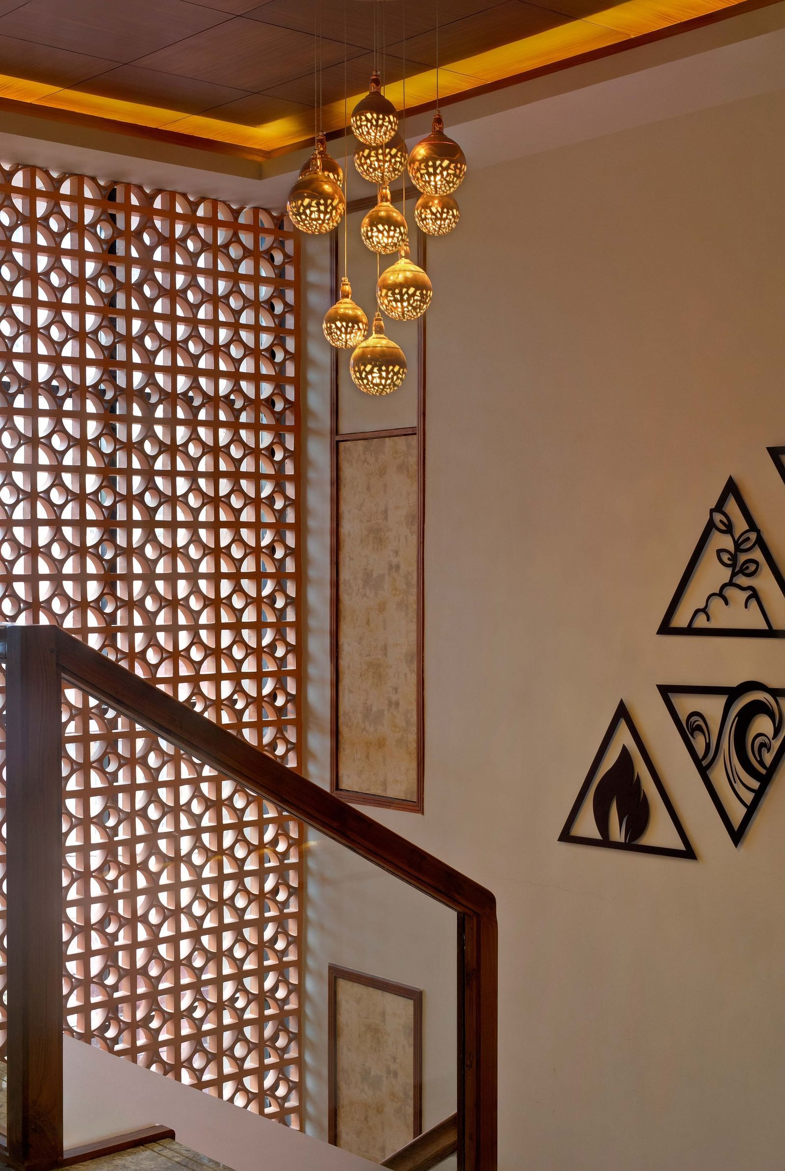 Image of a chandelier hanging from a lit up ceiling at Coral Reef Hotel and Spa in Port Blair