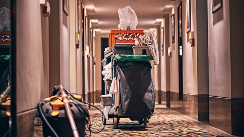 a vacuum cleaner and other room service supplies outside a hotel room
