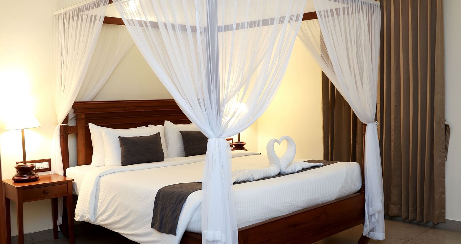 A four-poster bed beautifully decorated with fabric pieces | Mango Hill La Serene, Pondicherry