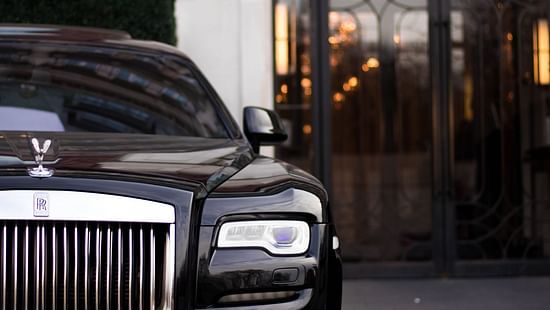 a luxury car parled at an entrance