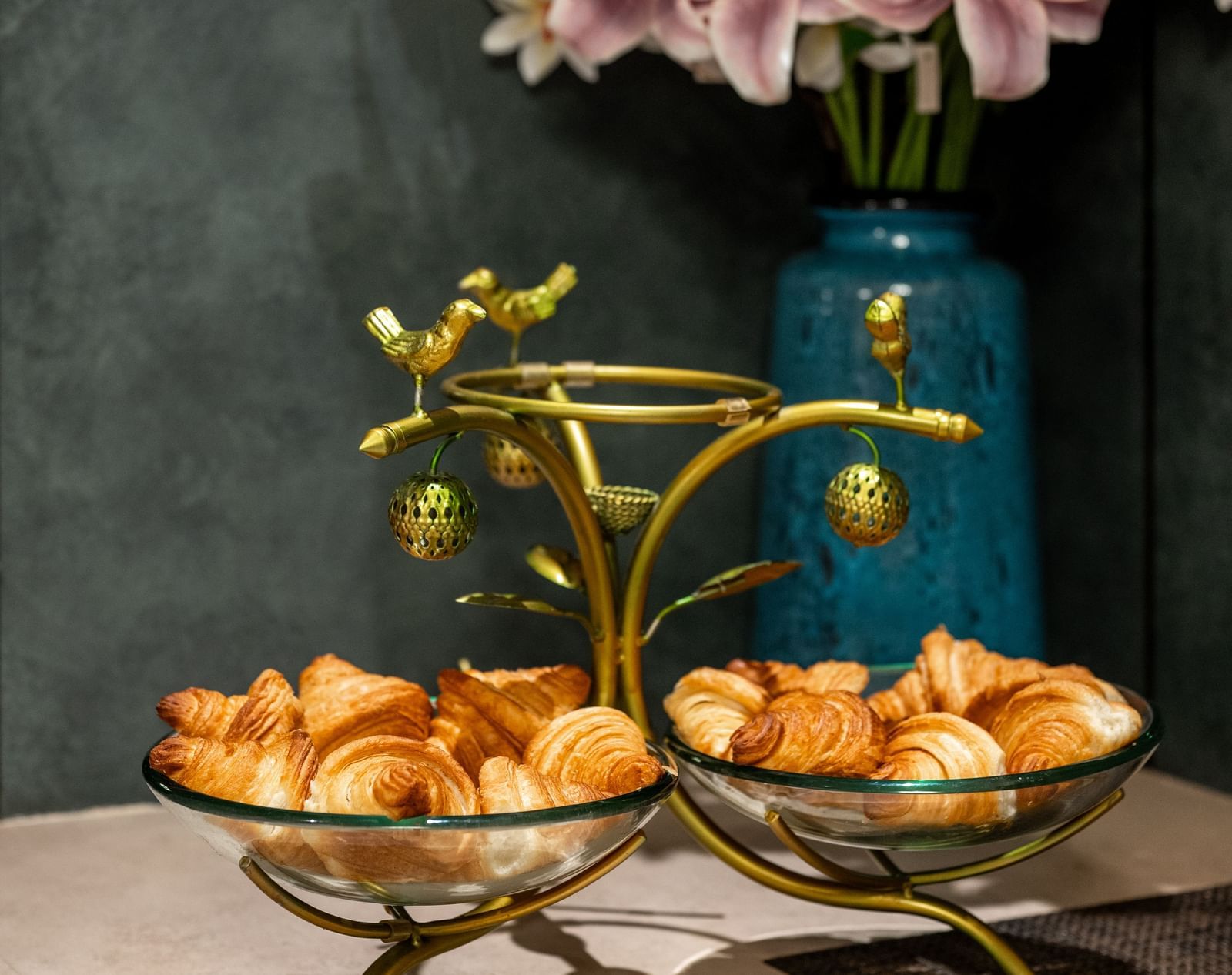 Flower arrangement with croissant displayed on a stand at Hotel Royal Regency Chennai
