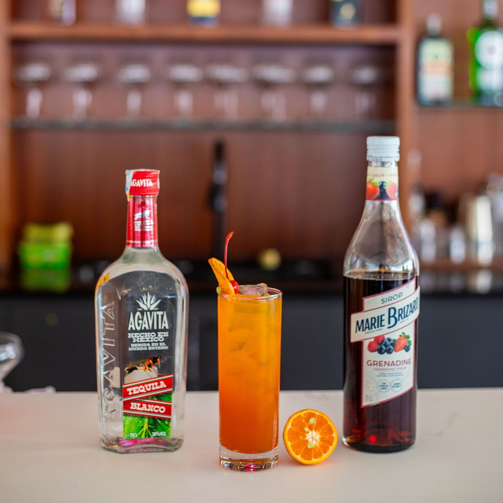 A cold beverage placed between bottles of Agavita Tequila and Marie Brizard at Mandala Norling Lords Prime, Kathmandu.