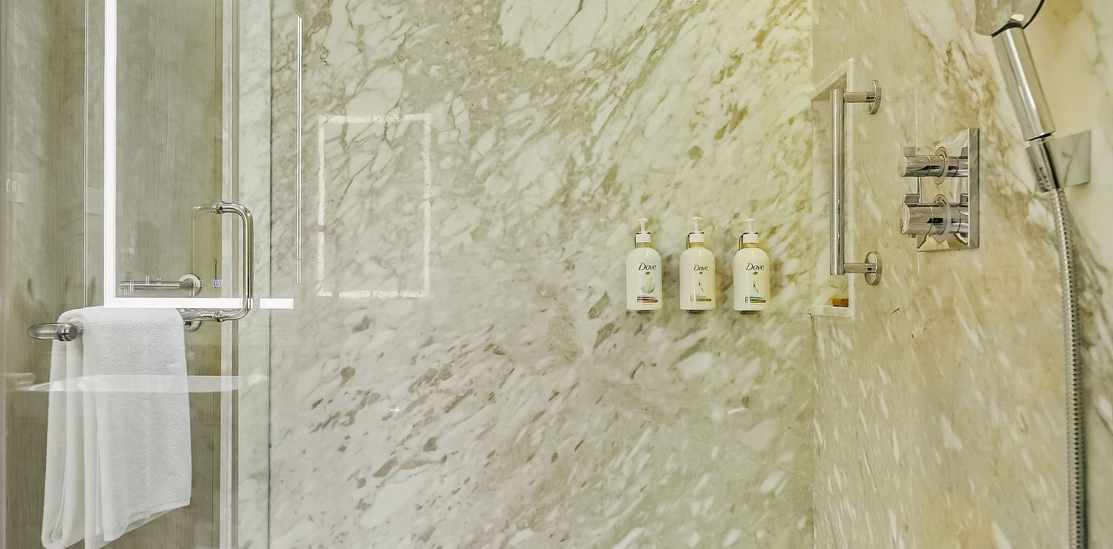 An image of the bathroom in our Executive Suite in Madurai with a shower cubicle and toiletries