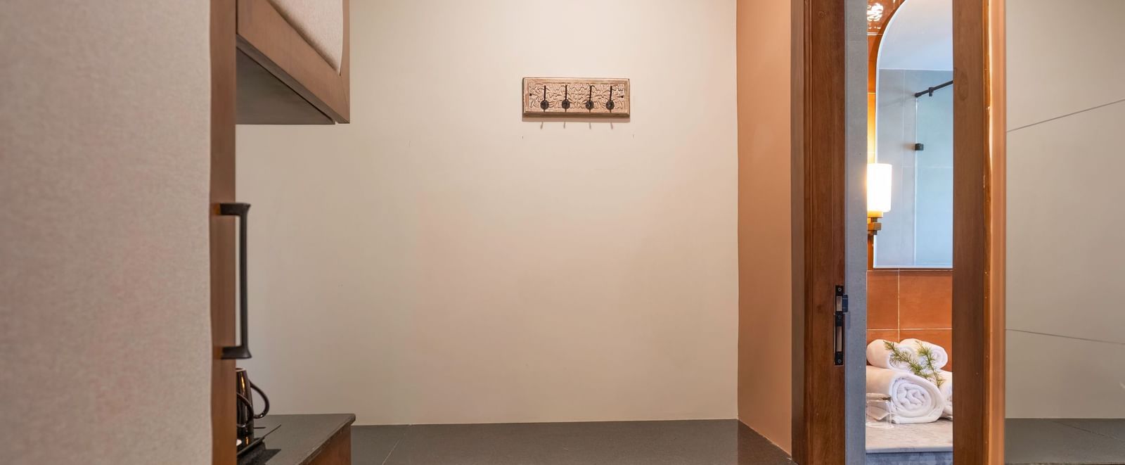 Narrow hallway with built-in storage cupboards at The Chamomile Estate.